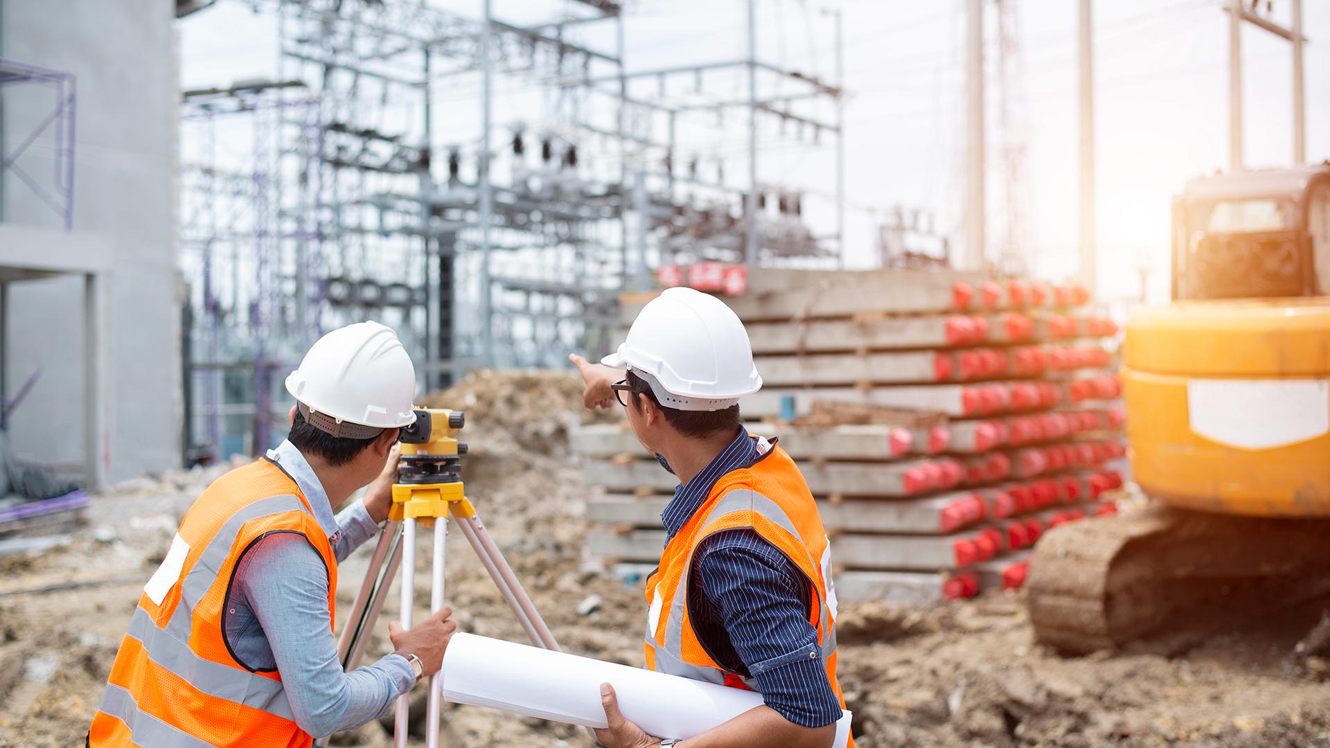 Asian surveyor engineer making measure with partner on the field