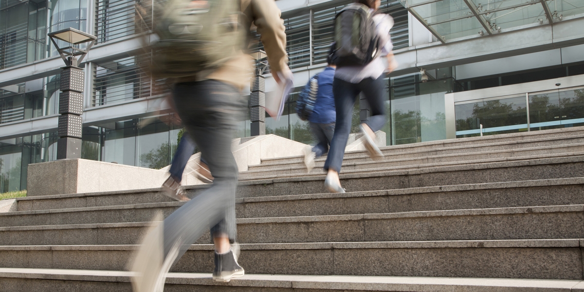 students running up steps on campus
