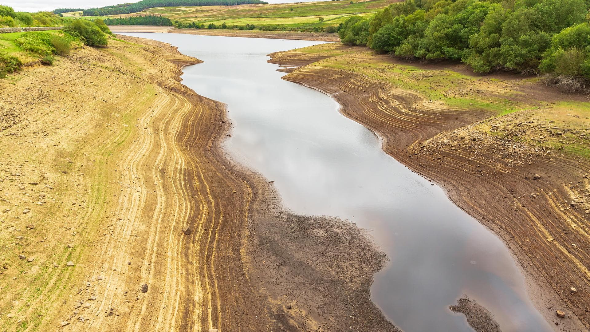 Leighton Reservoir in Nidderdale, North Yorkshire, UK, with very low water levels following a prolonged heatwave and no rainfall.