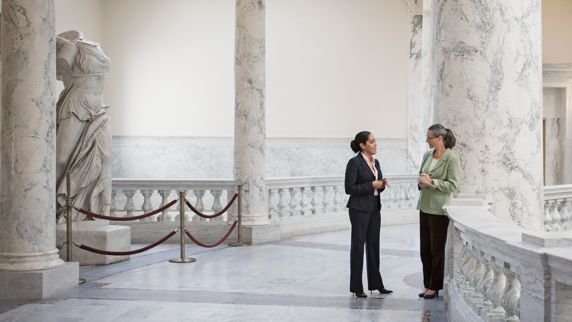 Two women speaking to each other in a U.S. Capitol building.