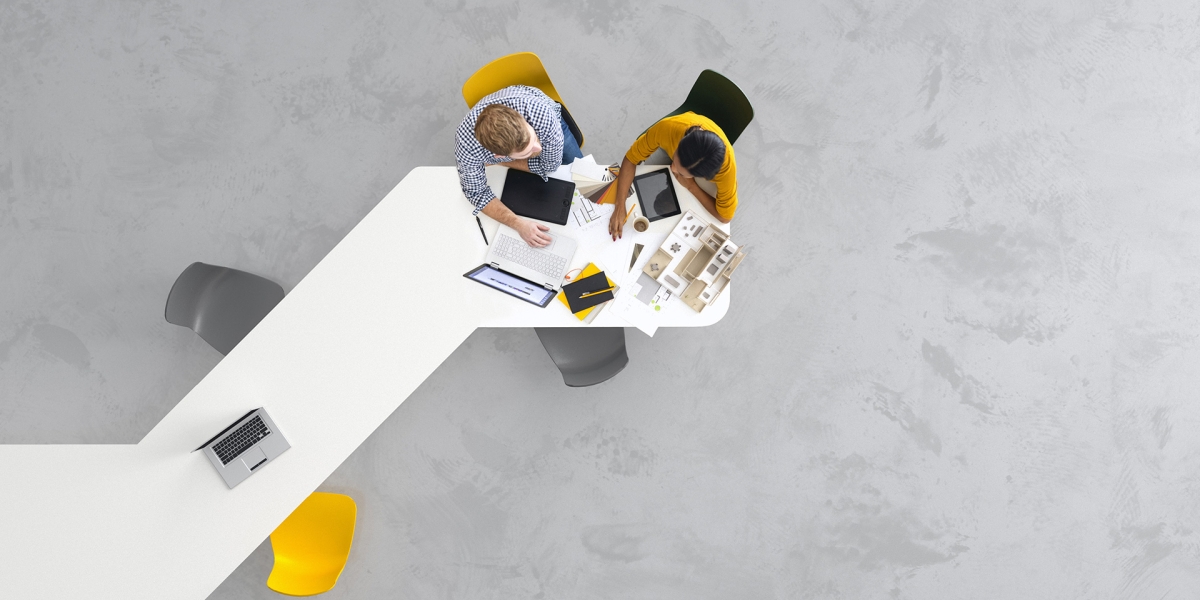 Aerial View of Two Architects at a Desk 