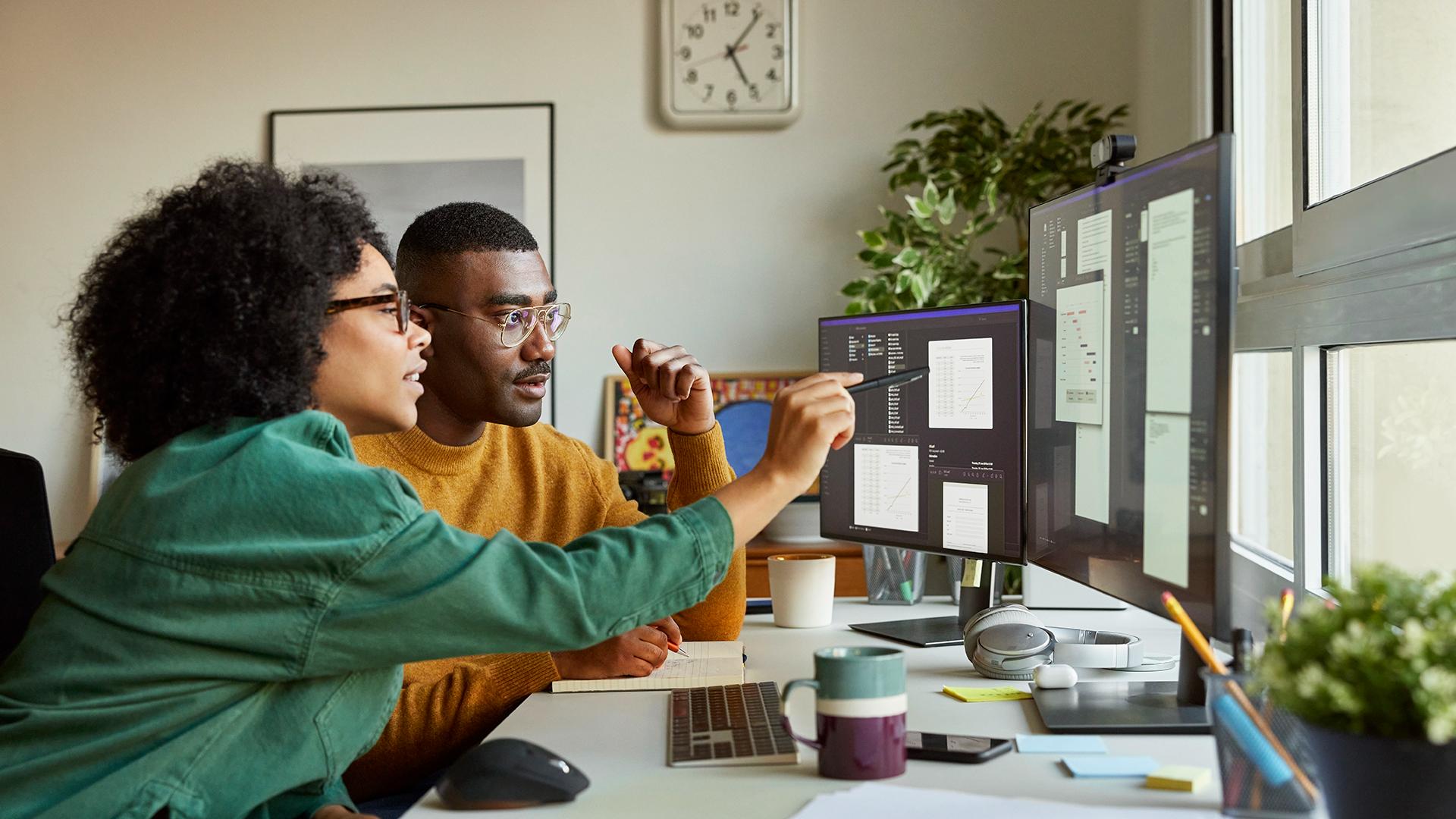 Multiracial colleagues discussing over computer - stock photo
