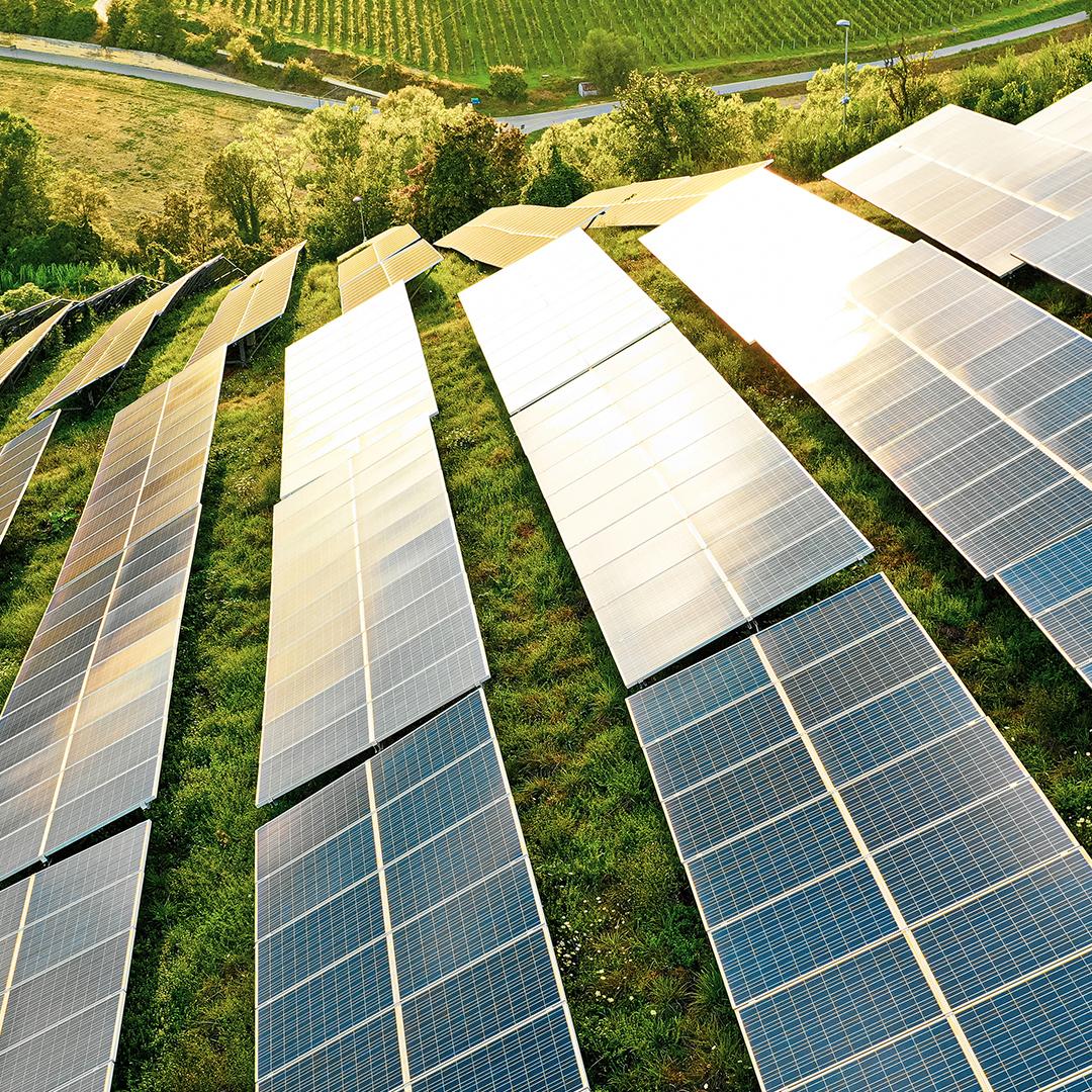 Solar panels fields on green hills
